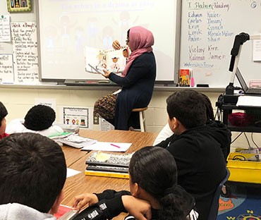 School board member Raaheela with a 5th-grade class and The Youngest Marcher